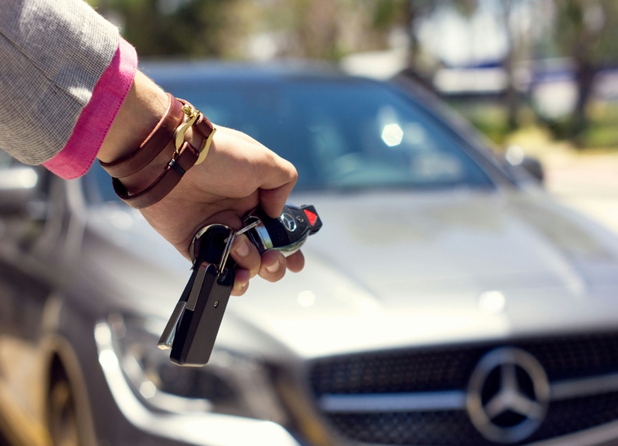 Customer receiving car keys after picking up a rental vehicle from Chaliko Car Hire