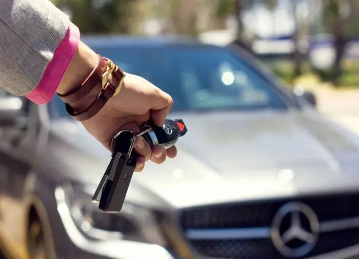 Customer receiving car keys after picking up a rental vehicle from Chaliko Car Hire